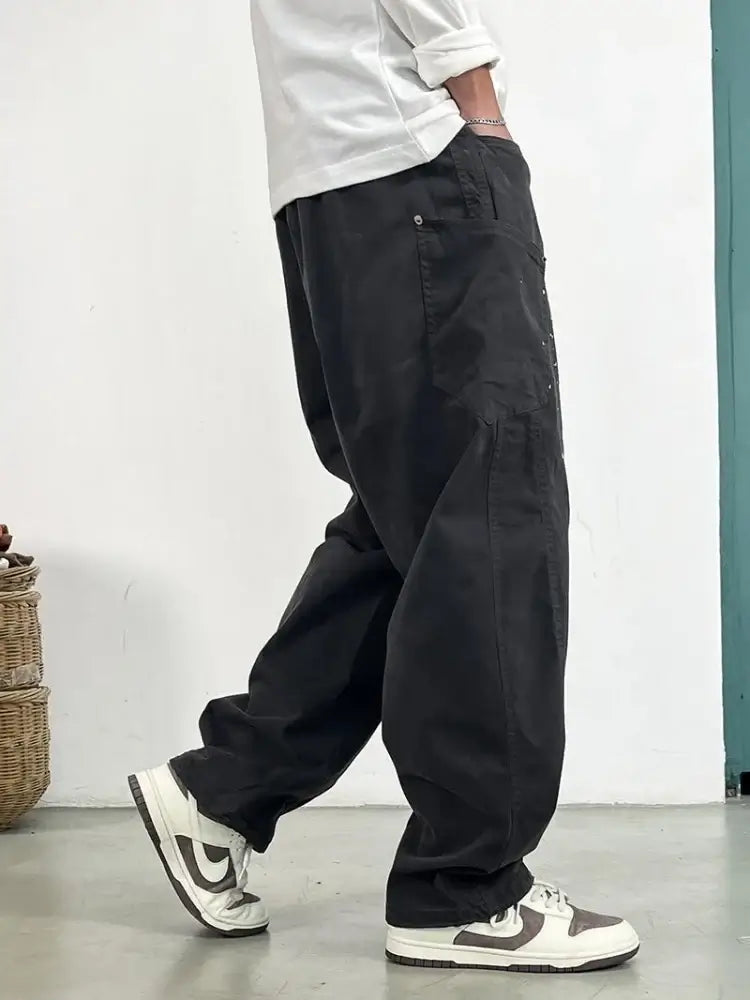 Stylish cargo pants for men in black, featuring a loose fit and side pockets, ideal for casual wear.