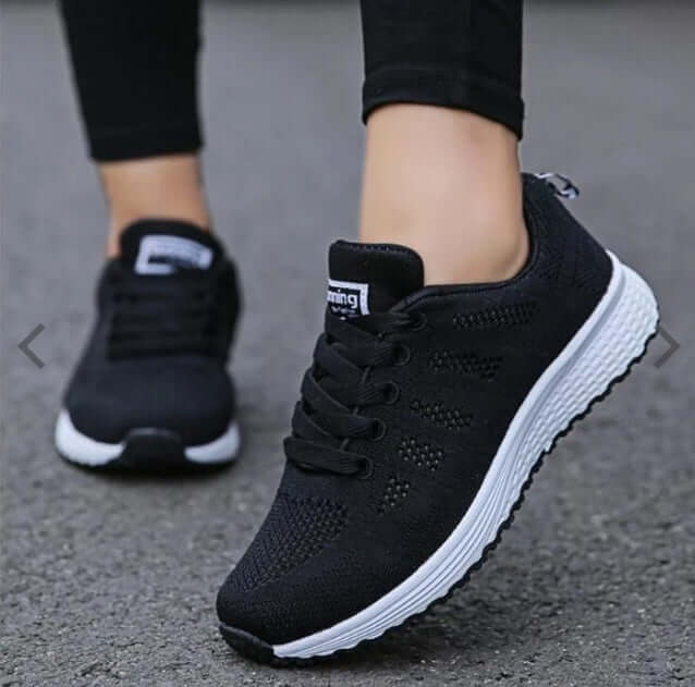 lightweight women's sports sneakers in black, perfect for running and casual wear, showcasing breathable design.