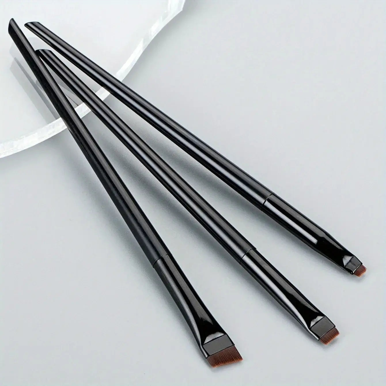 3pcs makeup brush set displayed, featuring sleek black handles and precision bristles for flawless makeup application.