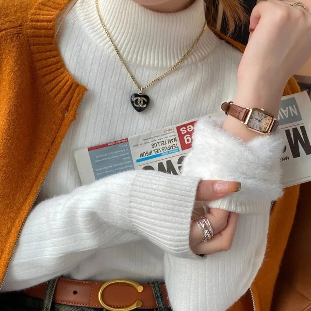 Stylish woman's winter turtleneck sweater featuring a ribbed design, worn with a cozy cardigan and accessories.