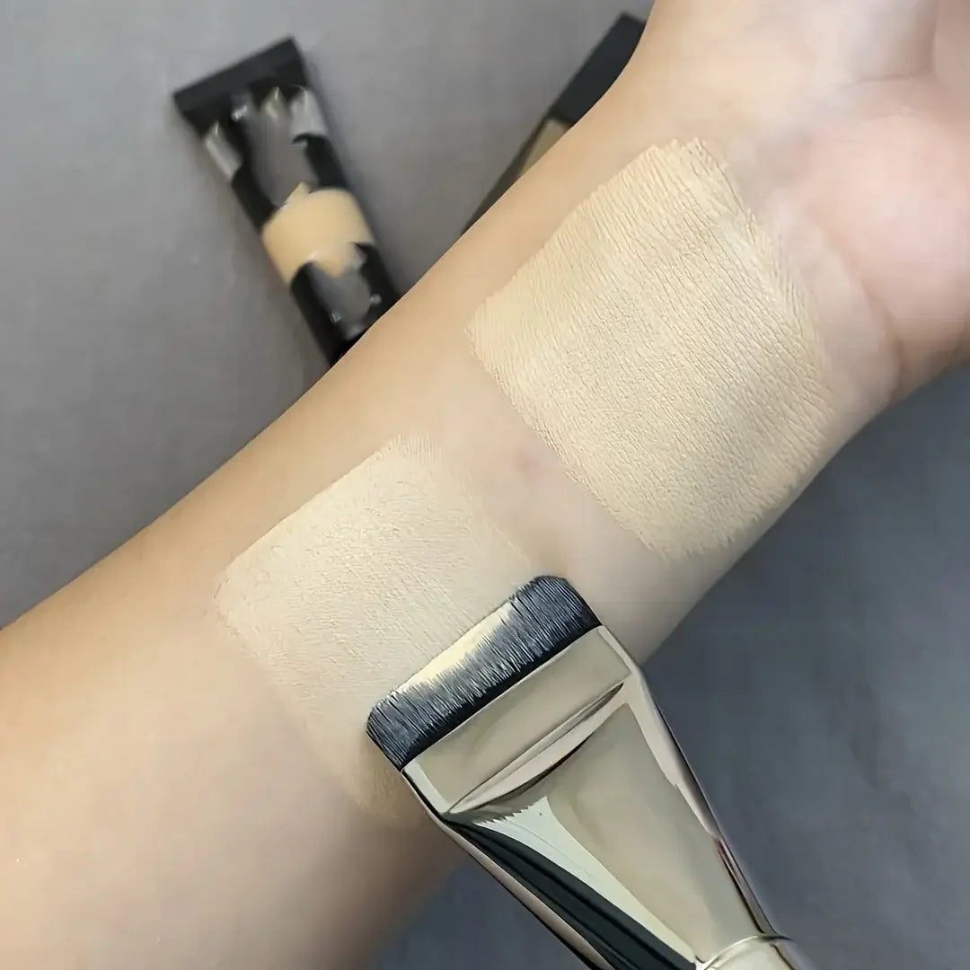 Image showing a hand applying foundation with nylon bristle paint brushes for a smooth finish.