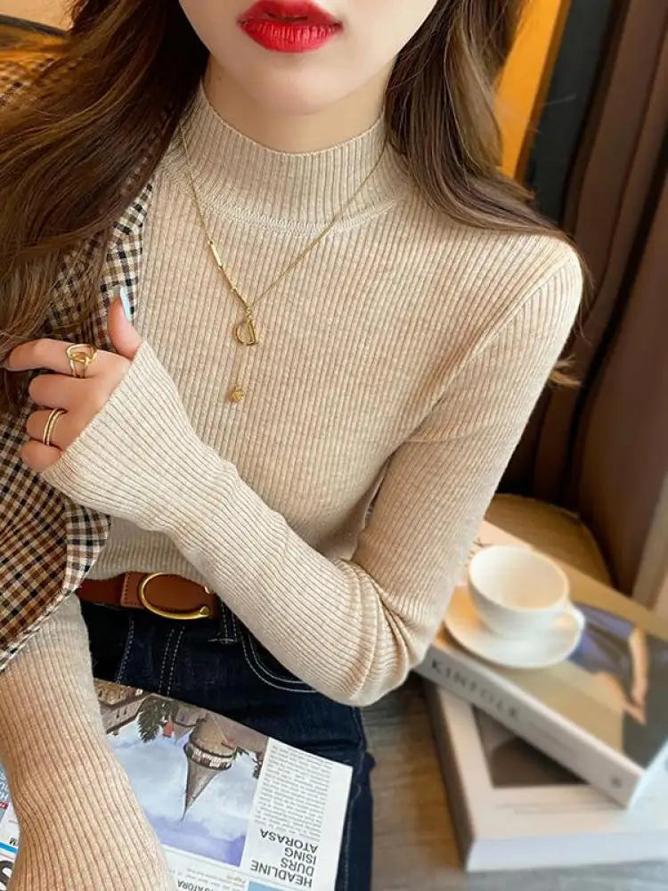 Close-up of a model wearing a vintage mock neck women sweater in beige, styled with accessories and a fashionable background.