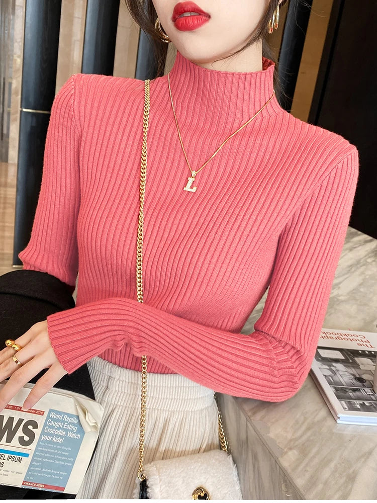 Elegant women's turtleneck long sleeve in pink ribbed design, perfect for layering in colder months.
