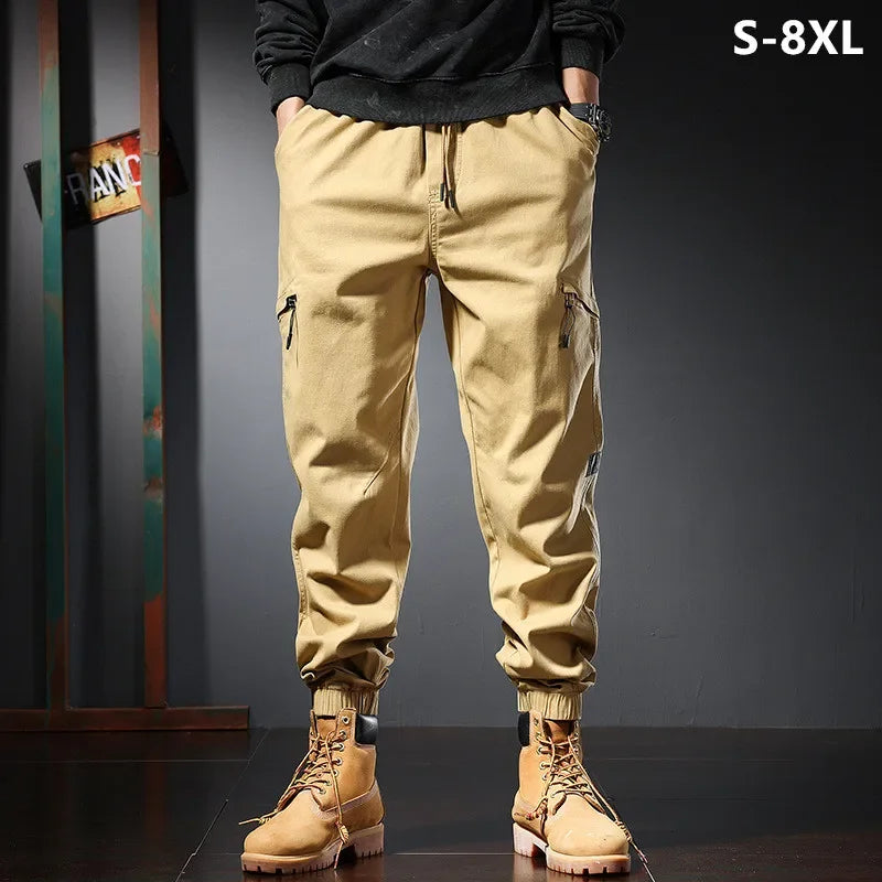 Cargo trousers for men displayed in a stylish setting, featuring a drawstring waist and multiple pockets.