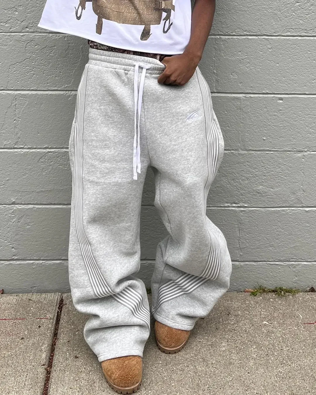 Casual loose straight leg pants worn by a person, showcasing unisex casual straight leg pants in light gray.