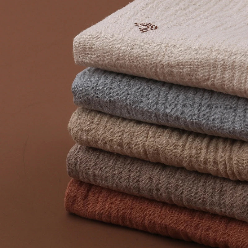 5PC baby washcloth set in various fashionable colors stacked neatly on a surface.