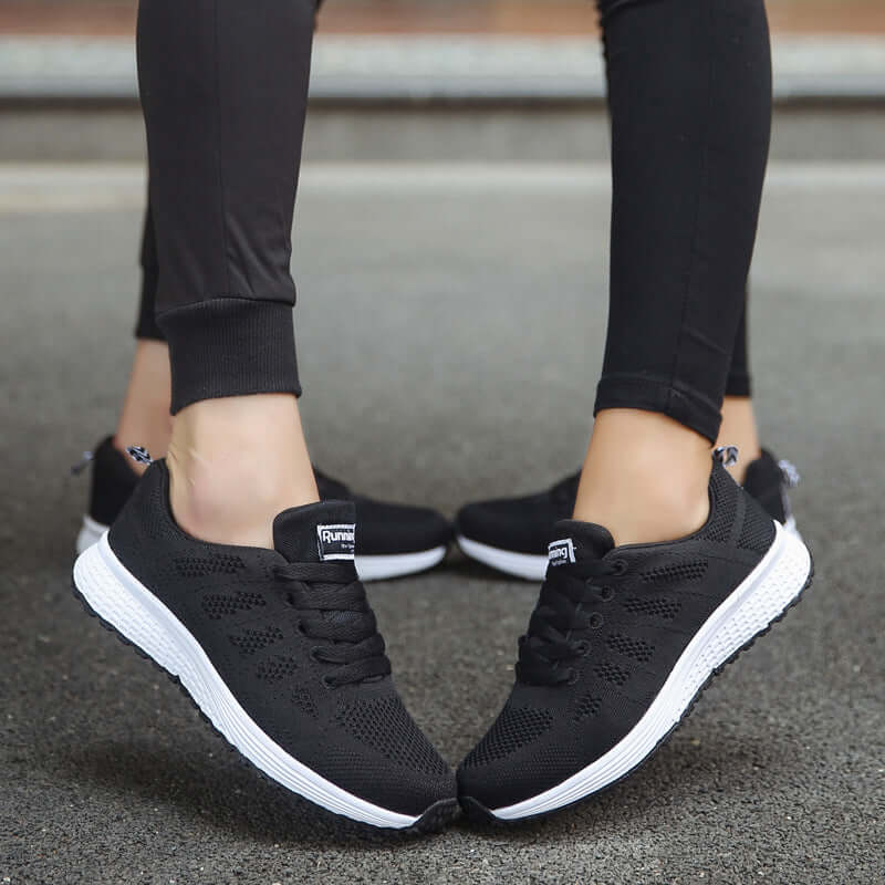 lightweight women's sports sneakers in black, perfect for running and casual wear, featuring breathable design and stylish look.