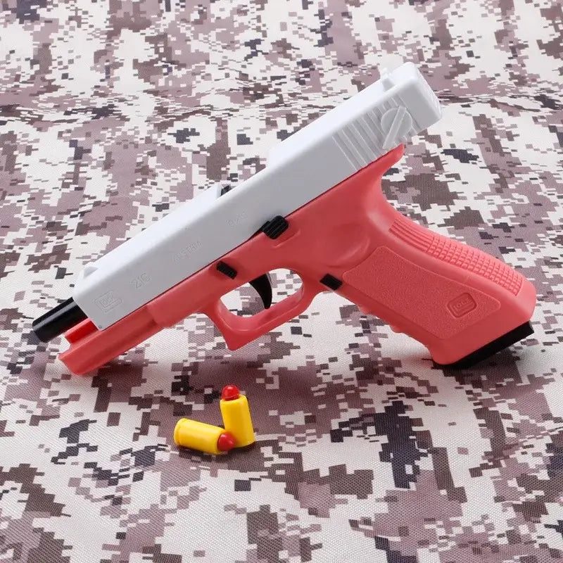 Soft bullet toy gun in pink and white with soft bullets on a camo background.