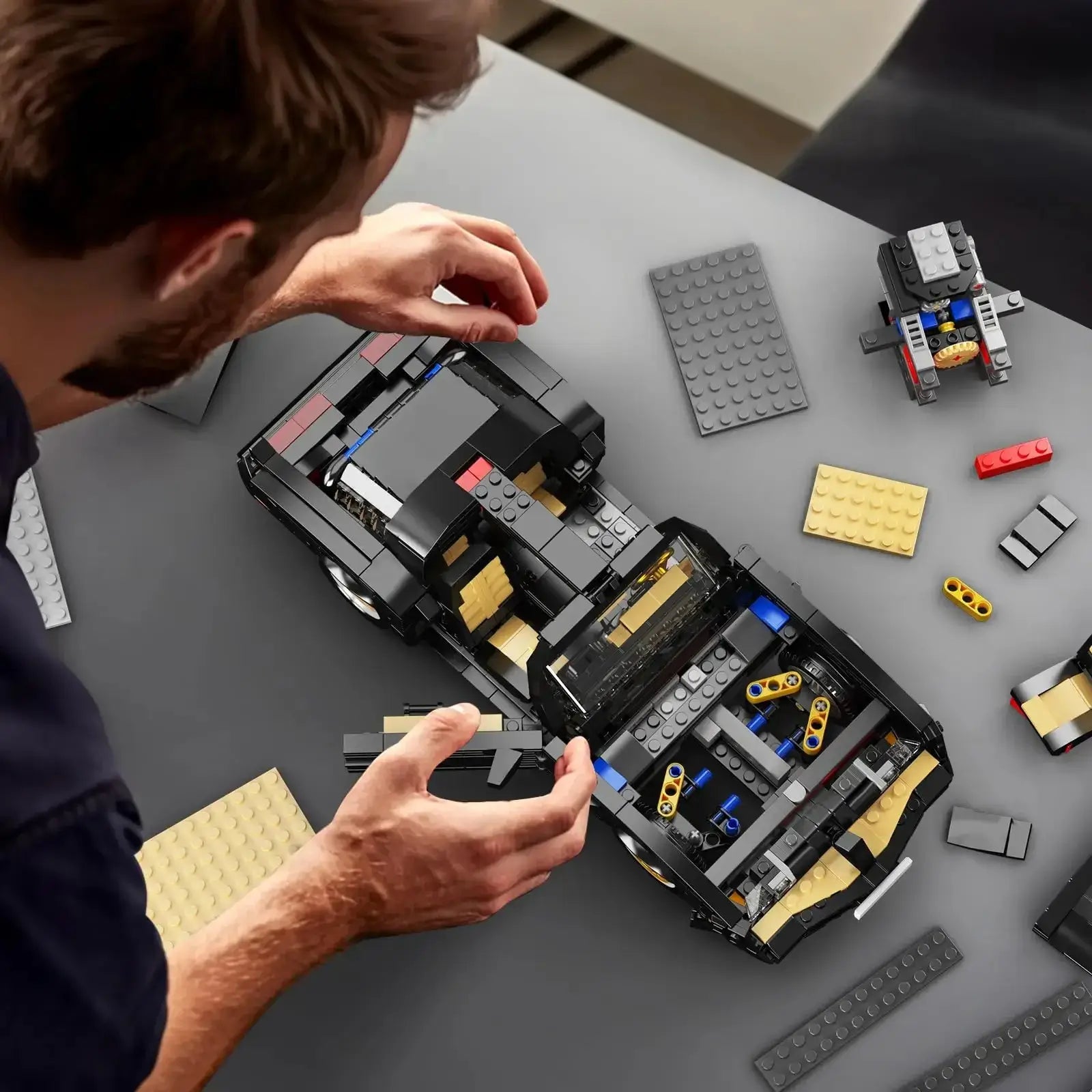 Building a vintage firebird car building blocks set with 1557PCS on a tabletop.