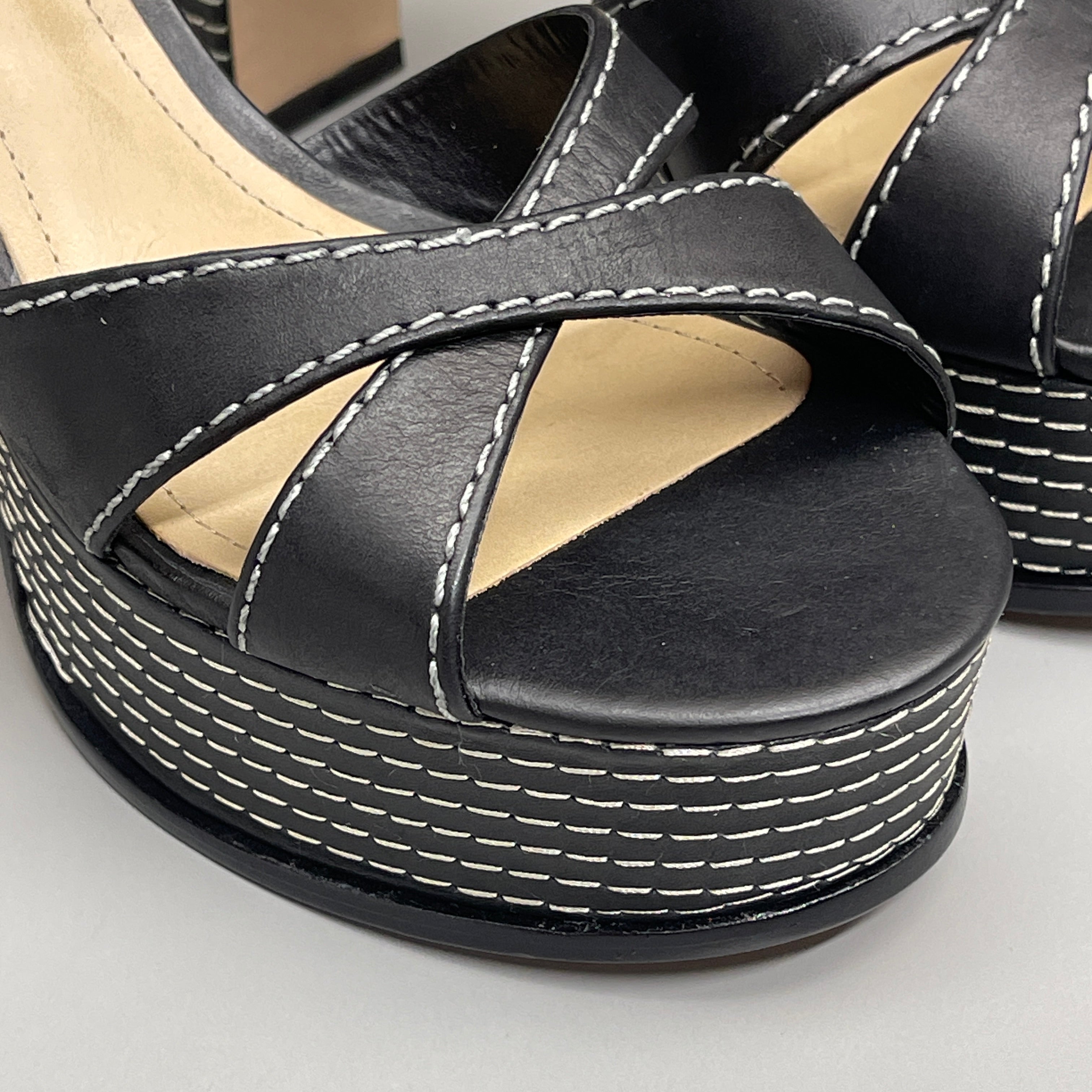 Close-up of SCHUTZ Keefa women's leather sandals, black platform shoes with cross straps and 4" heel.