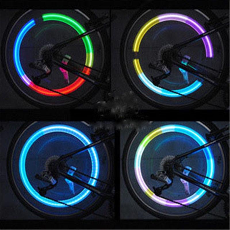 Bicycle wheel LED lights displaying vibrant colors for high visibility at night and improved safety on the road.